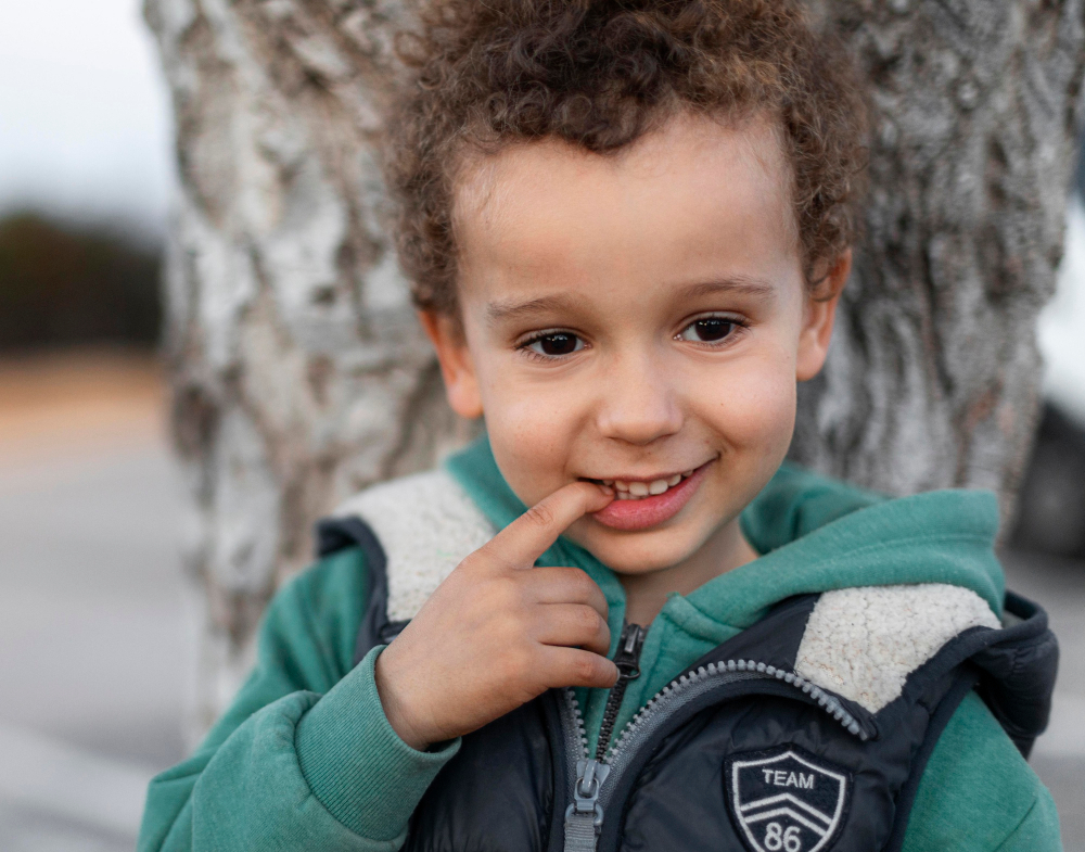 Un enfant appuyé sur un arbre