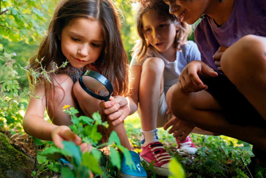 low angle kids with magnifying glass